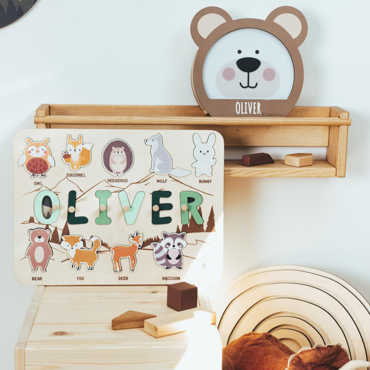 Wooden shelf with a name plaque, clock, and toy in a child's room