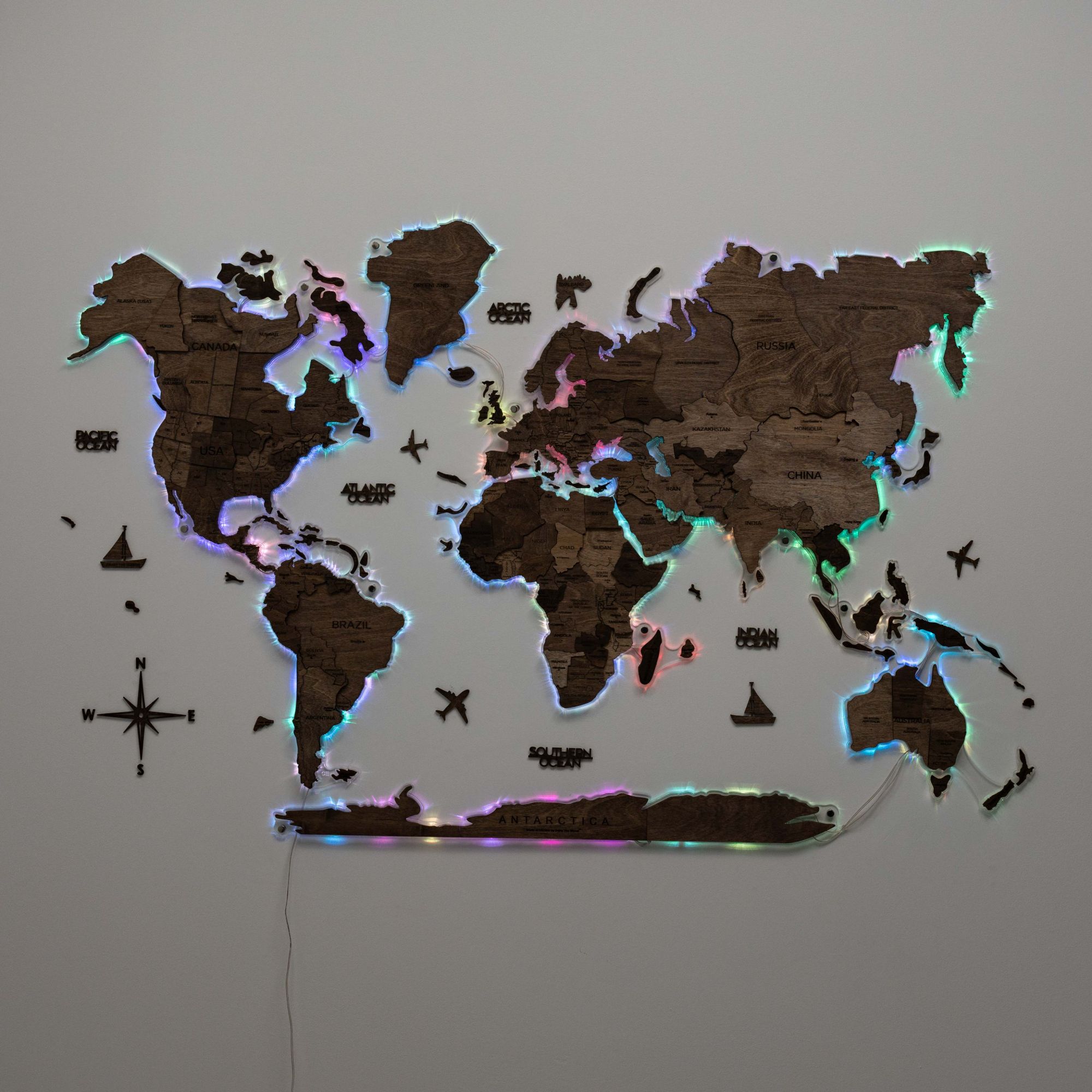 World map wall decoration with LED lights on a gray wall