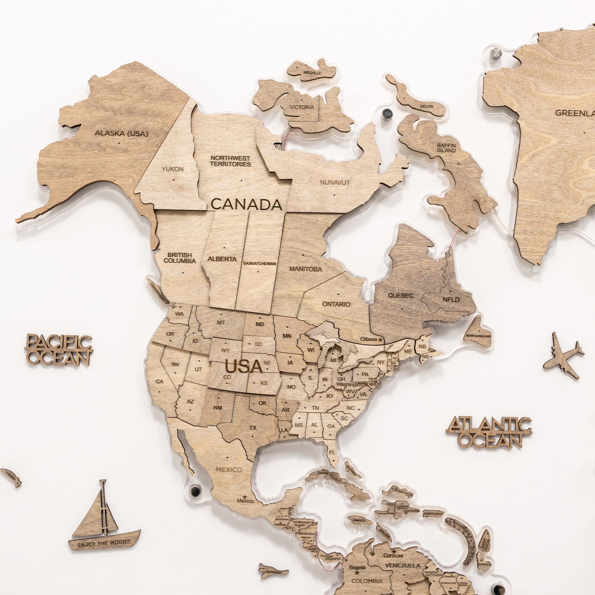 Wooden map of North America with labeled countries and oceans on a white background