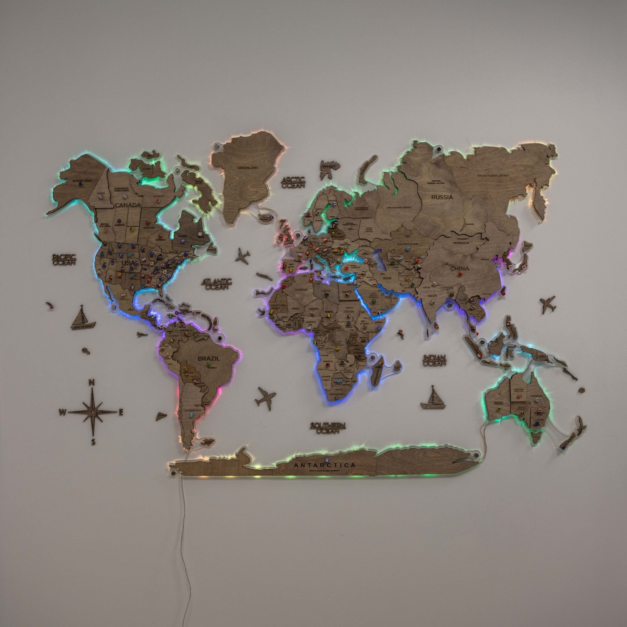 World map wall decoration with LED lighting on a plain wall