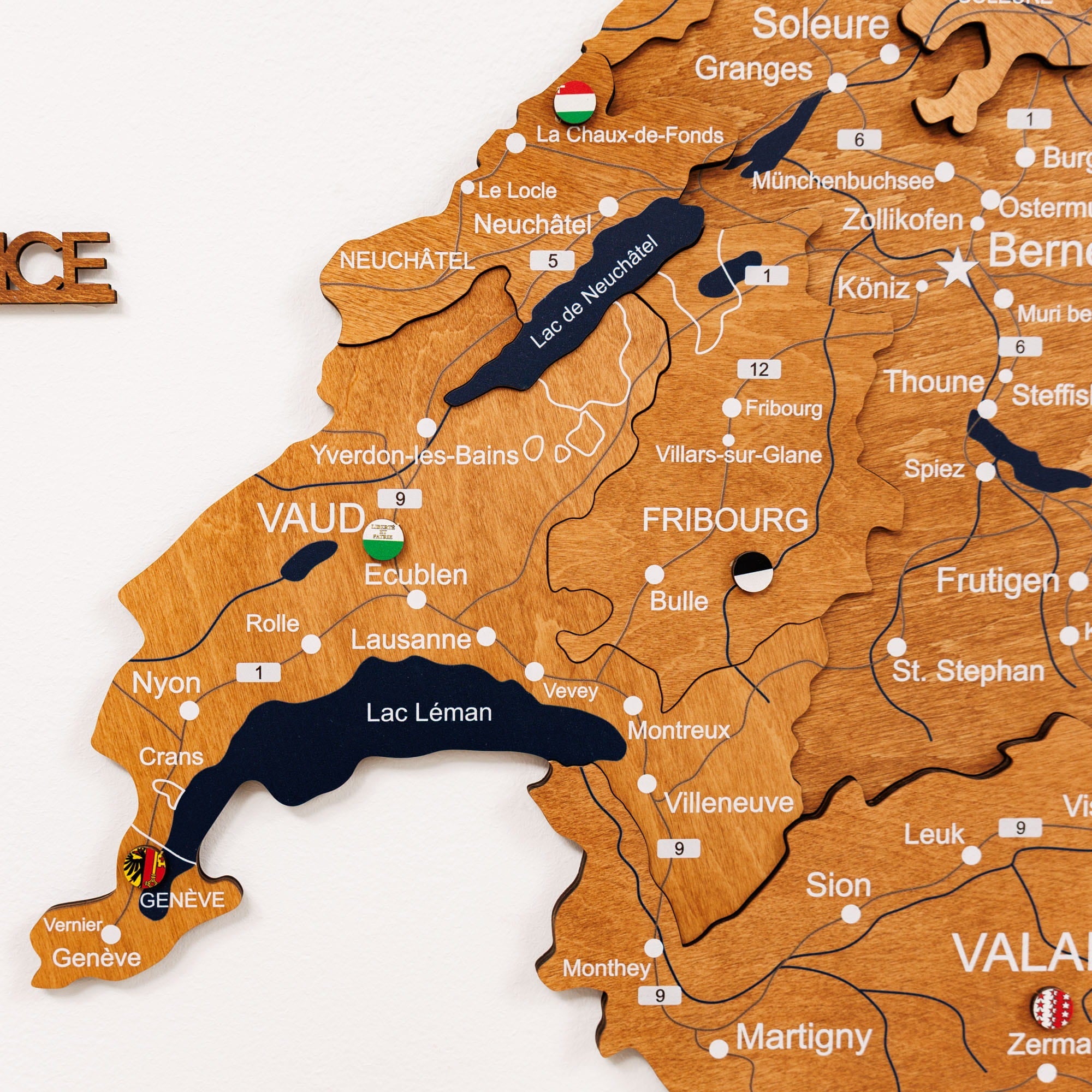 Wooden map of Switzerland with lakes and cities labeled