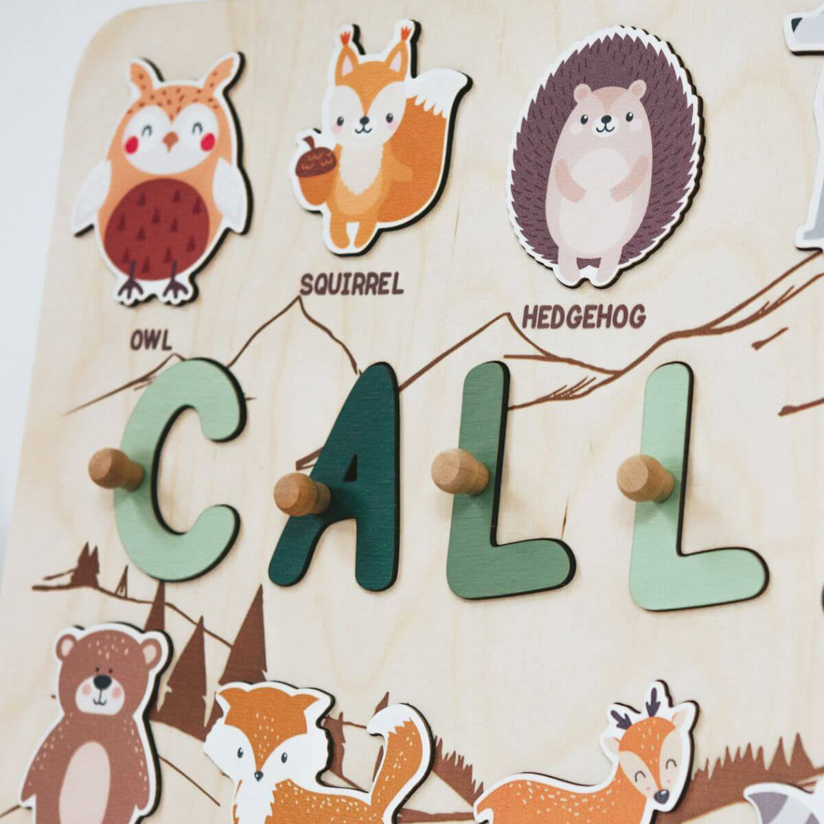 Wooden educational puzzle with animal illustrations and letters on a light wood background