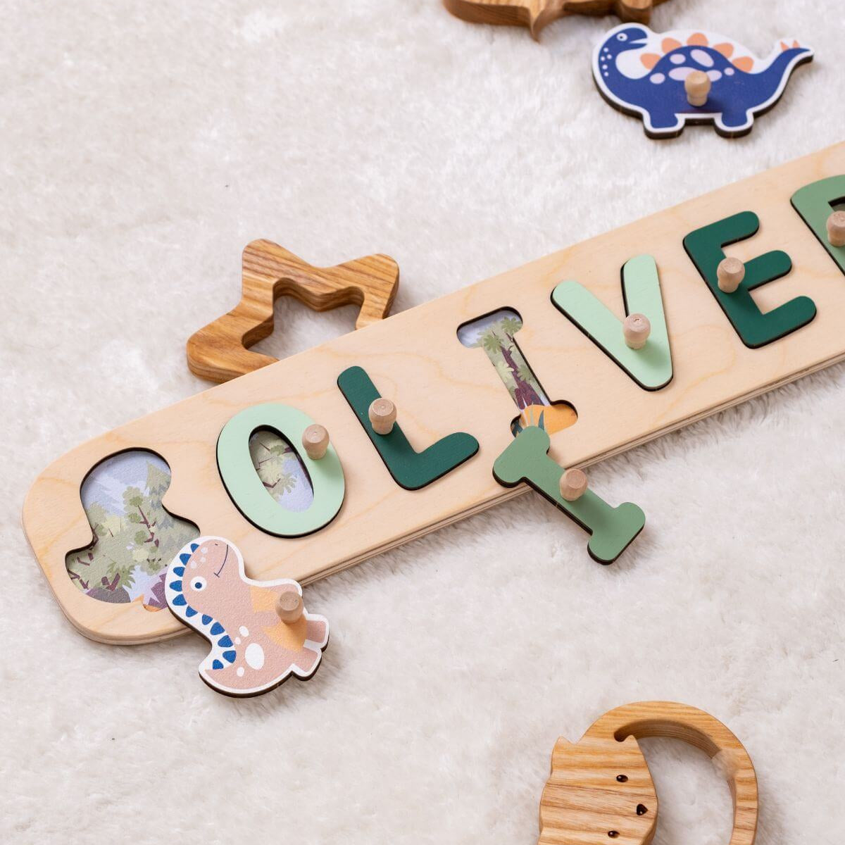 Wooden nameplate with cut-out letters spelling 'OLIVER' on a light background