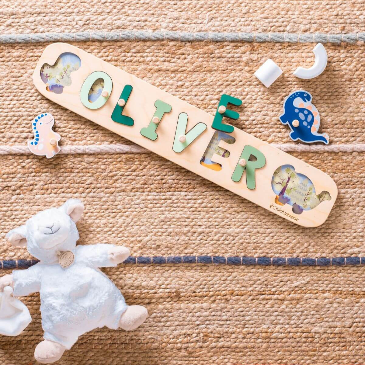 Wooden name puzzle with letters spelling 'OLIVER' on a textured surface with toys.