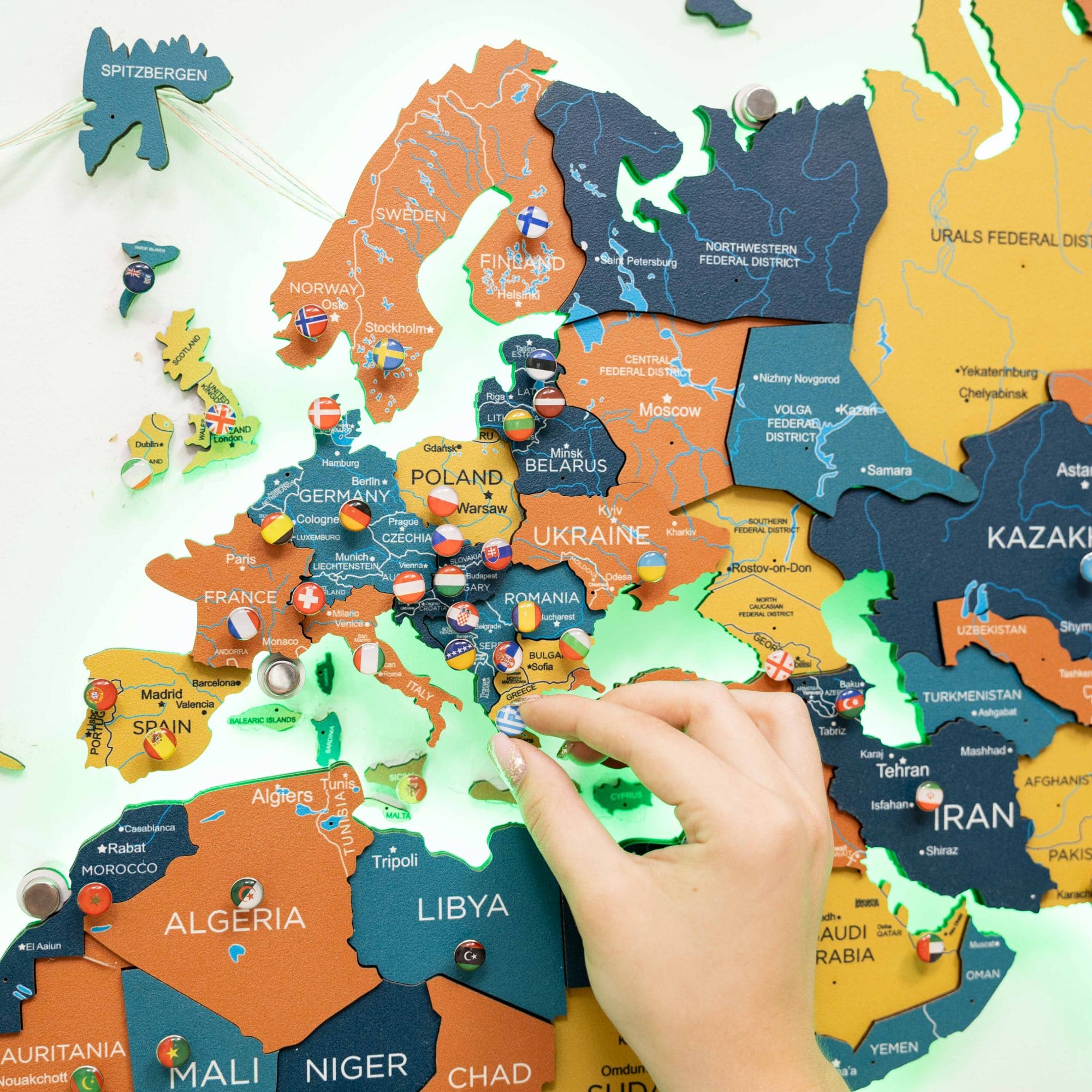 World map puzzle with a hand placing a piece in position